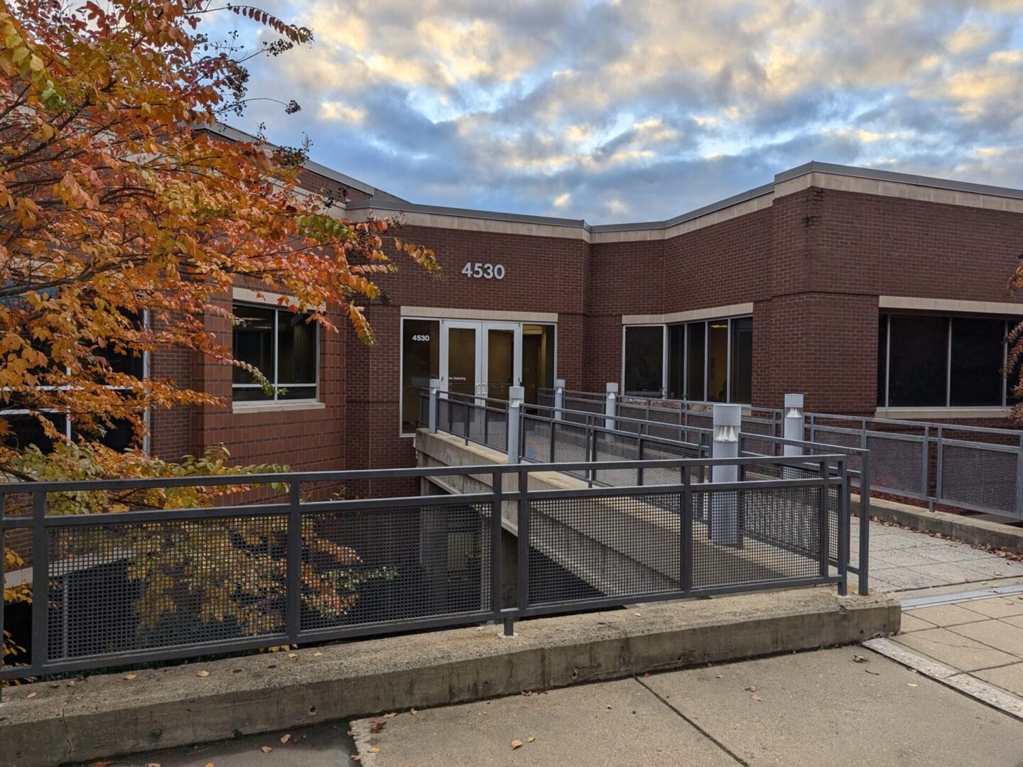 A building with a metal fence and stairs.