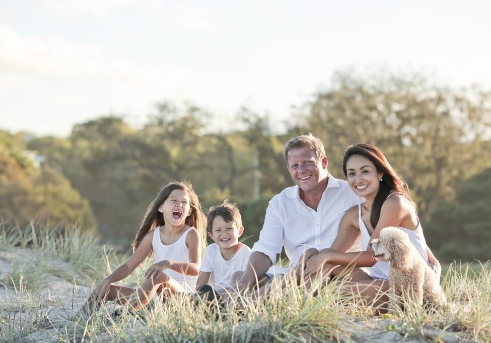 A family sitting in the grass together